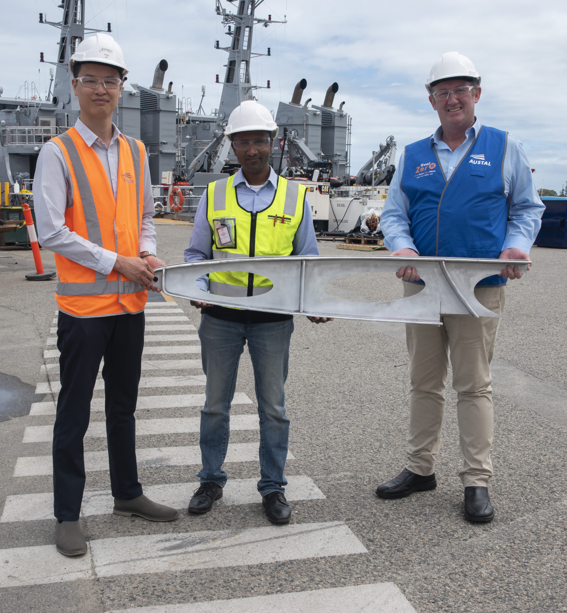 From Left: Austal Technology Project Manager Jeffrey Poon, DNV Representative Jude Stanislaus, AML3D Chief Technology Officer Andy Sales with a sample of the davit produced during the additive manufacturing project. (image: Austal Australia)